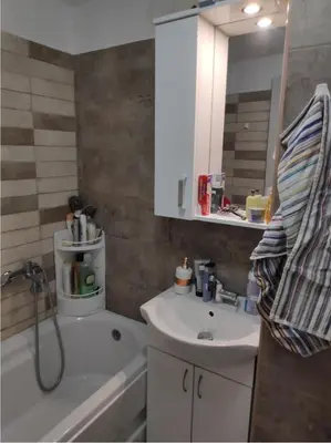 a bathroom with a sink and a mirror and a tub at Nikolaj in Podgorica