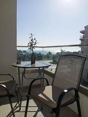 a table and chairs in a room with a window at OLIVA apartment BAR in Bar