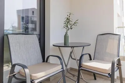 two chairs and a table with a vase on it at OLIVA apartment BAR in Bar