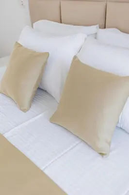 a white bed with four pillows on it at OLIVA apartment BAR in Bar