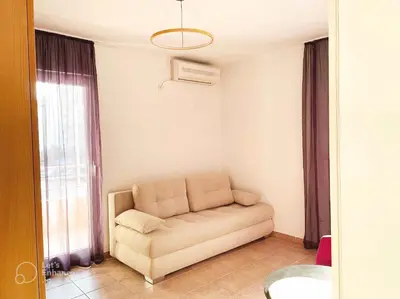 a living room with a couch and a window at Amonte in Budva