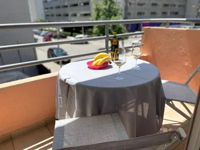 a table with a bottle of wine and glasses on a balcony at Amonte in Budva