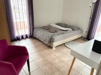 a living room with a bed and a chair at Amonte in Budva