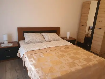 a bedroom with a large bed with two night stands at Villa Blanca in Bar