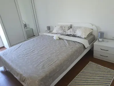 a bed with a teddy bear laying on it in a bedroom at Villa Blanca in Bar
