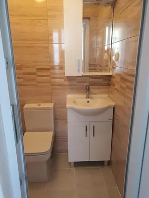 a bathroom with a toilet and a sink and a mirror at Villa Blanca in Bar