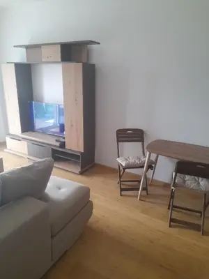 a living room with a couch and a table and a tv at Apart Anastasija in Bar