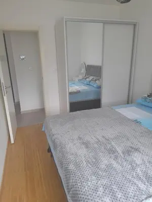 a bedroom with two beds and a mirror at Apart Anastasija in Bar