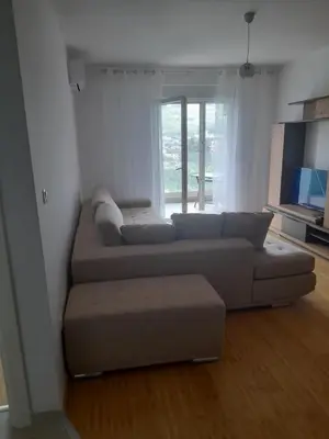 a living room with a couch and a large window at Apart Anastasija in Bar