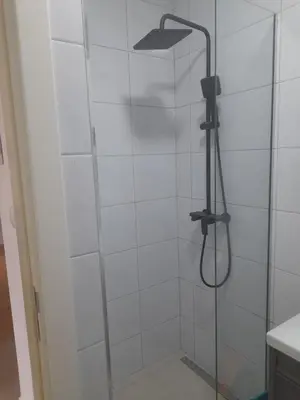 a bathroom with a shower with a glass door at Apart Anastasija in Bar