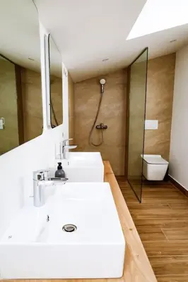 a bathroom with a white sink and a shower at Penthouse TivatHeights Pool & Sea View-B4 in Kavač