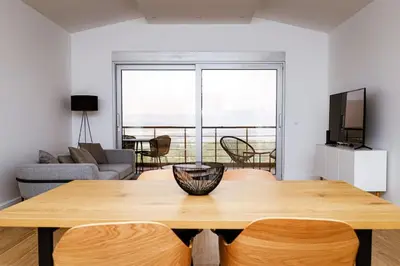 a living room with a wooden table and a television at Penthouse TivatHeights Pool & Sea View-B4 in Kavač