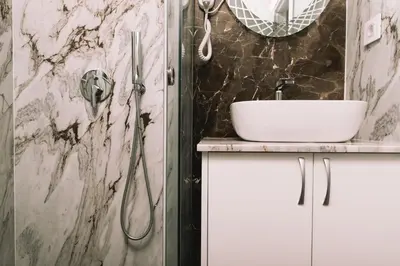 a bathroom with a sink and a shower at Apartments Moon White Lux in Ulcinj
