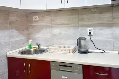 a kitchen counter top with a sink and a sink at Nikki’s Apartment Podgorica in Podgorica