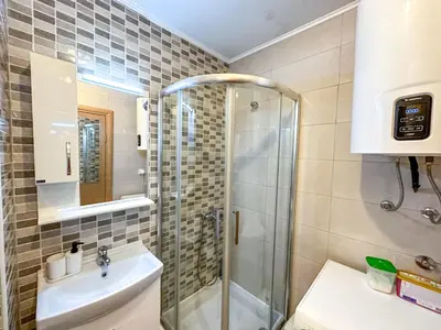 a bathroom with a shower and a sink at Nikki’s Apartment Podgorica in Podgorica