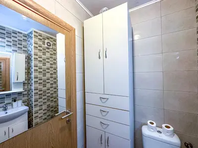 a bathroom with a toilet and a sink and a mirror at Nikki’s Apartment Podgorica in Podgorica