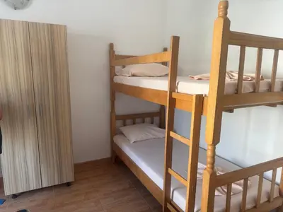 a room with two bunk beds and a closet at Vila Almas in Ulcinj