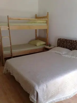 a bedroom with a bed and two bunk beds at Vila Almas in Ulcinj