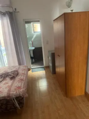 a bedroom with a bed and a wooden cabinet at Vila Almas in Ulcinj