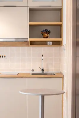 a kitchen with white cabinets and a sink at Higo Apartments in Ulcinj