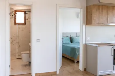 a bedroom with a bed and a bathroom at Higo Apartments in Ulcinj