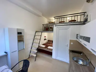 a small room with a bunk bed and a sink at Sutorange in Sutomore
