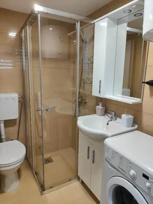 a bathroom with a shower and a toilet and a sink at Sutorange in Sutomore