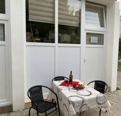a table with a plate of fruit on a patio at Sutorange in Sutomore