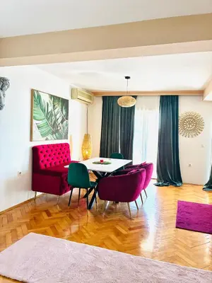 a living room with a red couch and a table at Waves View in Ulcinj