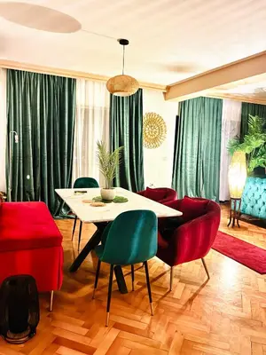 a dining room with green curtains and a table and chairs at Waves View in Ulcinj