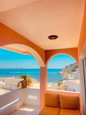 a room with a couch and a view of the ocean at Waves View in Ulcinj