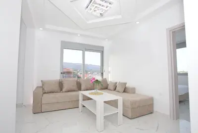 a living room with a couch and a table at NESI Apartments in Ulcinj