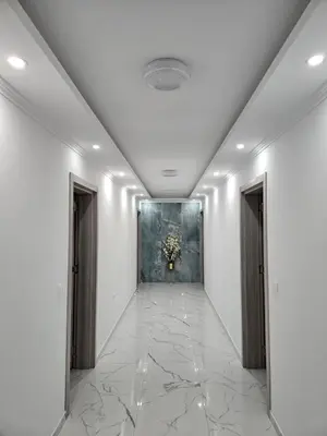 a hallway with white walls and a painting on the wall at NESI Apartments in Ulcinj