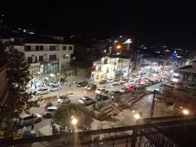 a busy city street at night with cars parked at Ulpiana - Apartments,Rooms,Hostel in Ulcinj