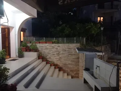 a stairway with potted plants and a brick wall at Ulpiana - Apartments,Rooms,Hostel in Ulcinj