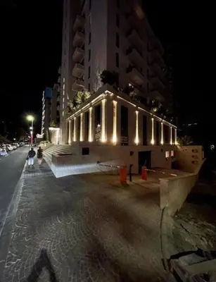 a building on the side of a street at night at Azure Horizon in Becici