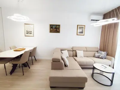 a living room with a couch and a table at Azure Horizon in Becici