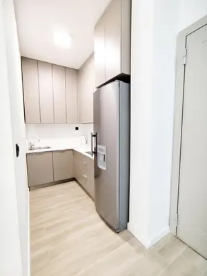 a kitchen with a stainless steel refrigerator in a room at Azure Horizon in Becici