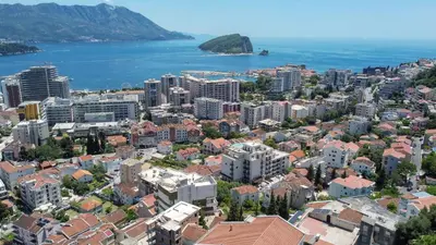 an aerial view of a city and the ocean at Harmonia Hills Apartments in Budva