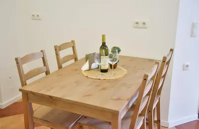 a wooden table with two bottles of wine and glasses at Harmonia Hills Apartments in Budva