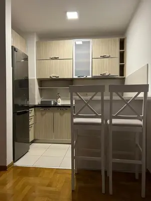 a kitchen with a counter and a chair in it at Apartment Shine in Konik
