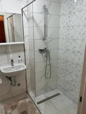 a bathroom with a shower and a sink at Apartment Shine in Konik