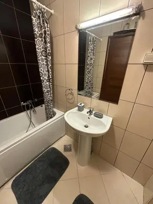 a bathroom with a sink and a bath tub and a sink at Big apartment 2 in Podgorica