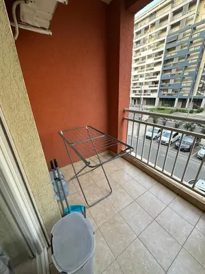 a metal rack on a balcony with a view of a building at Big apartment 2 in Podgorica
