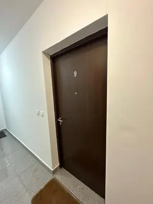 a brown door with the number on it at Big apartment 2 in Podgorica