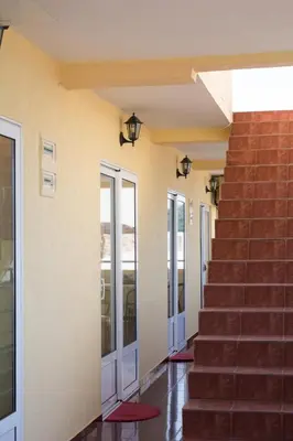 a hallway of a building with stairs and doors at Apartments and Studios Anicic in Utjeha