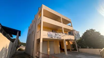 a building under construction with a blue sky in the background at Apartments and Studios Anicic in Utjeha