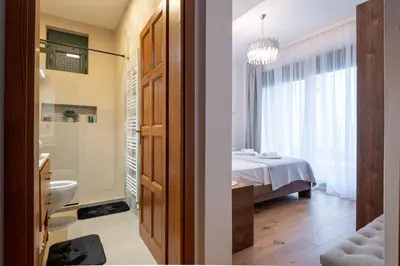 a bathroom with a toilet and a bathroom with a bed at White Hill Villa in Masline