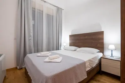 a bedroom with a bed with two towels on it at White Hill Villa in Masline