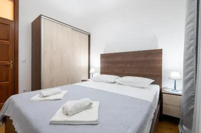 a bedroom with a bed with two towels on it at White Hill Villa in Masline